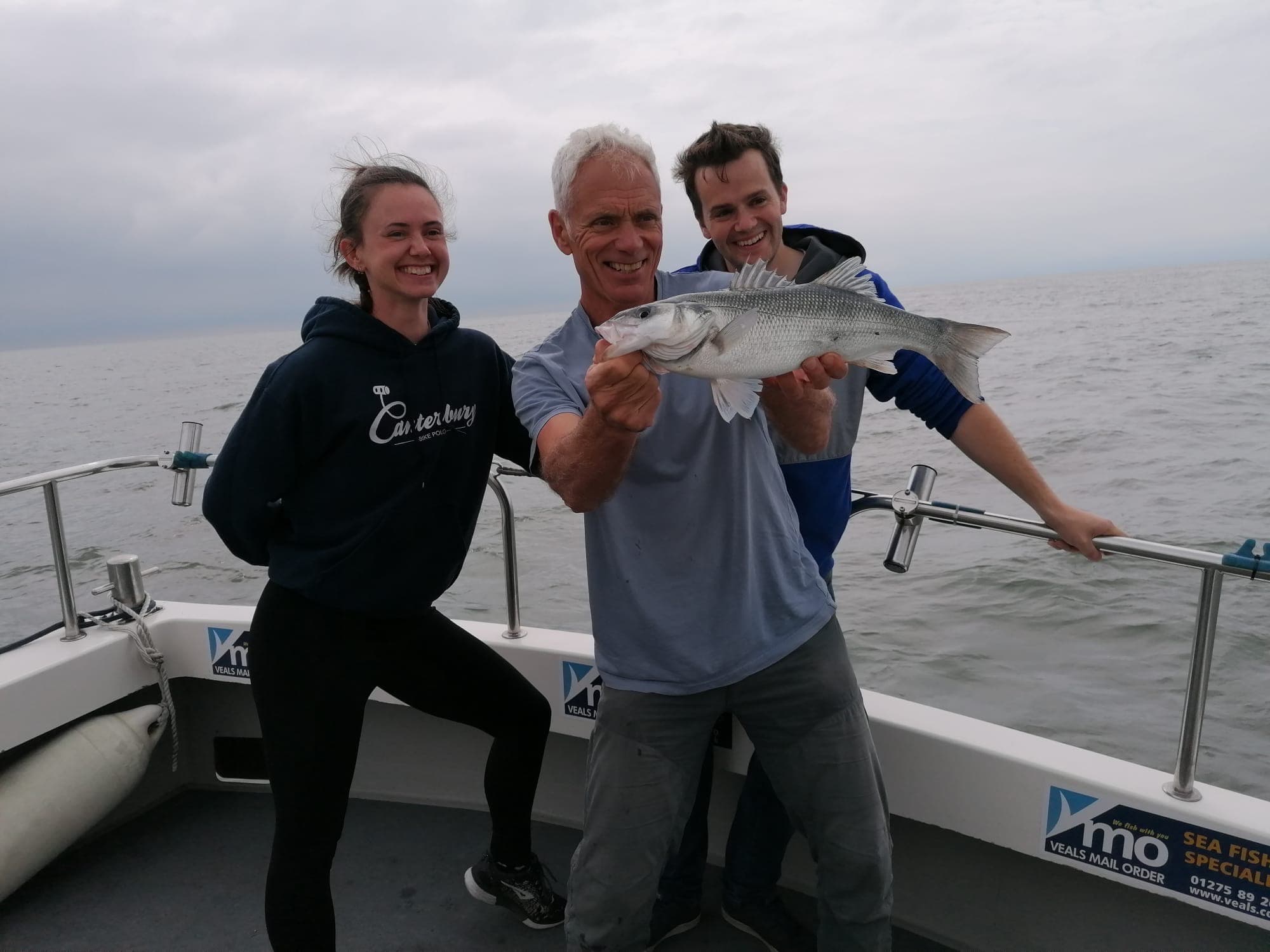 Anglers celebrating a fine Bristol Channel bass on the back deck