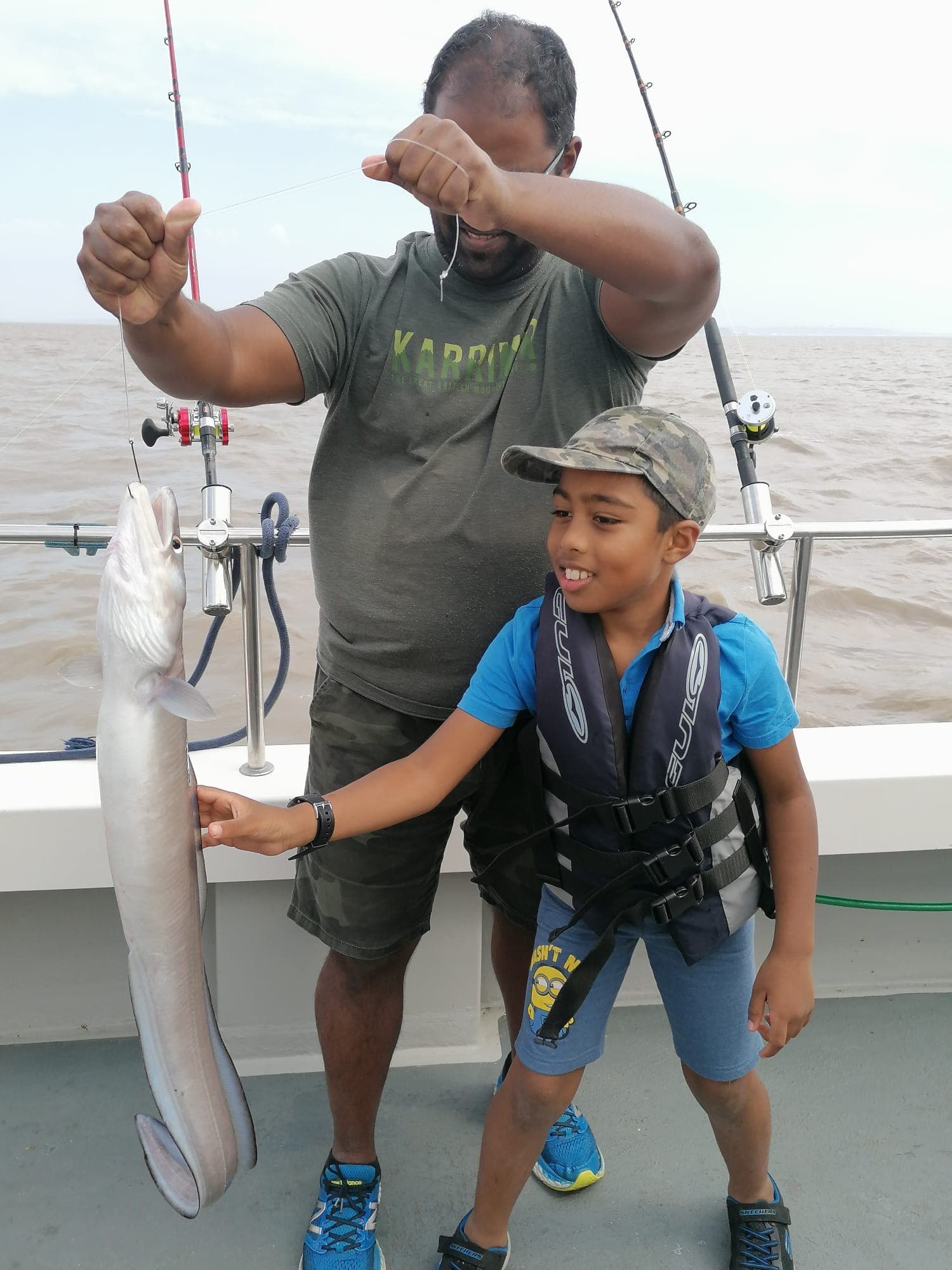 A young angler holding a conger eel from a Bristol Channel wreck