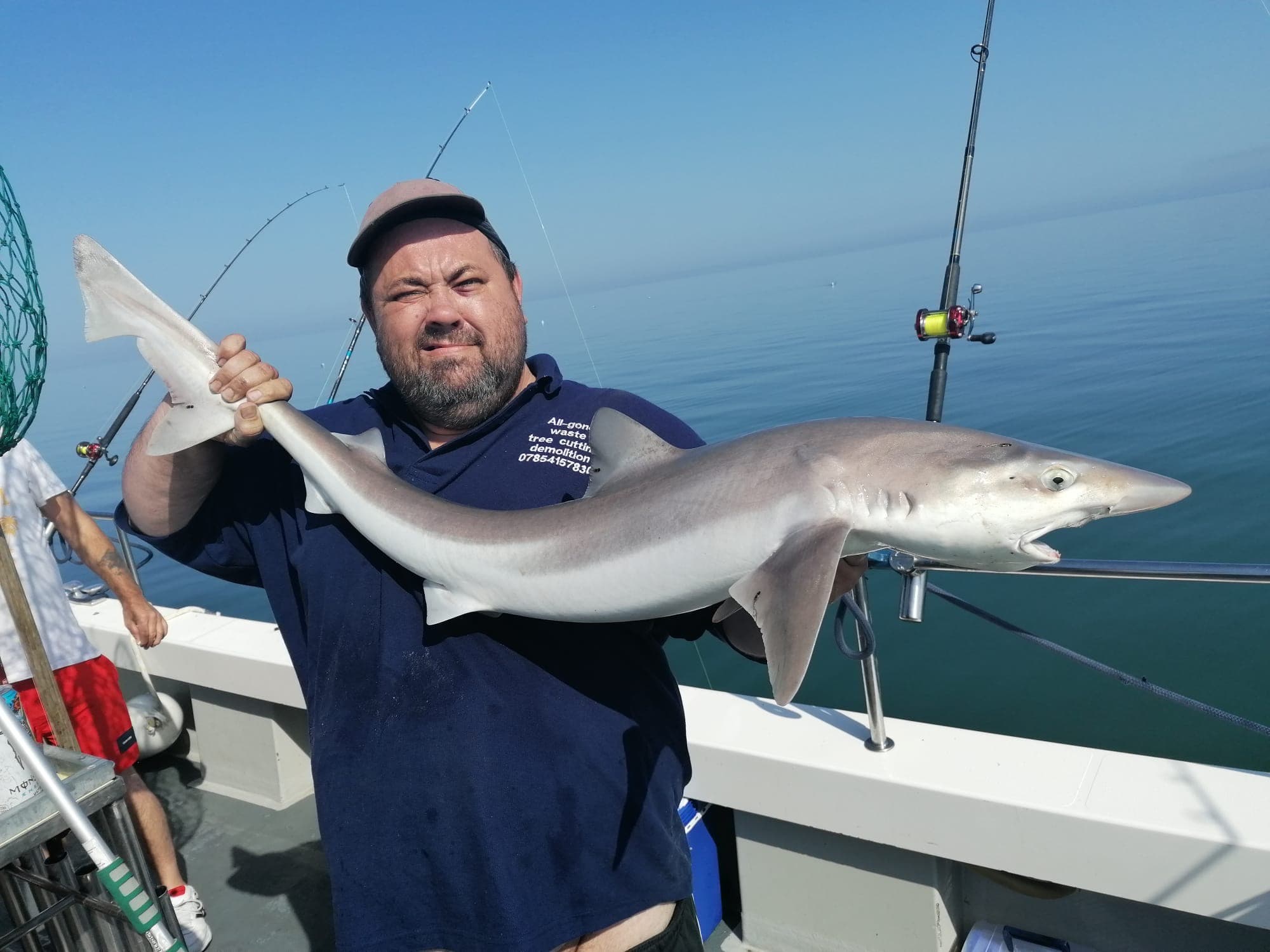 An angler with a Bristol Channel tope before its release