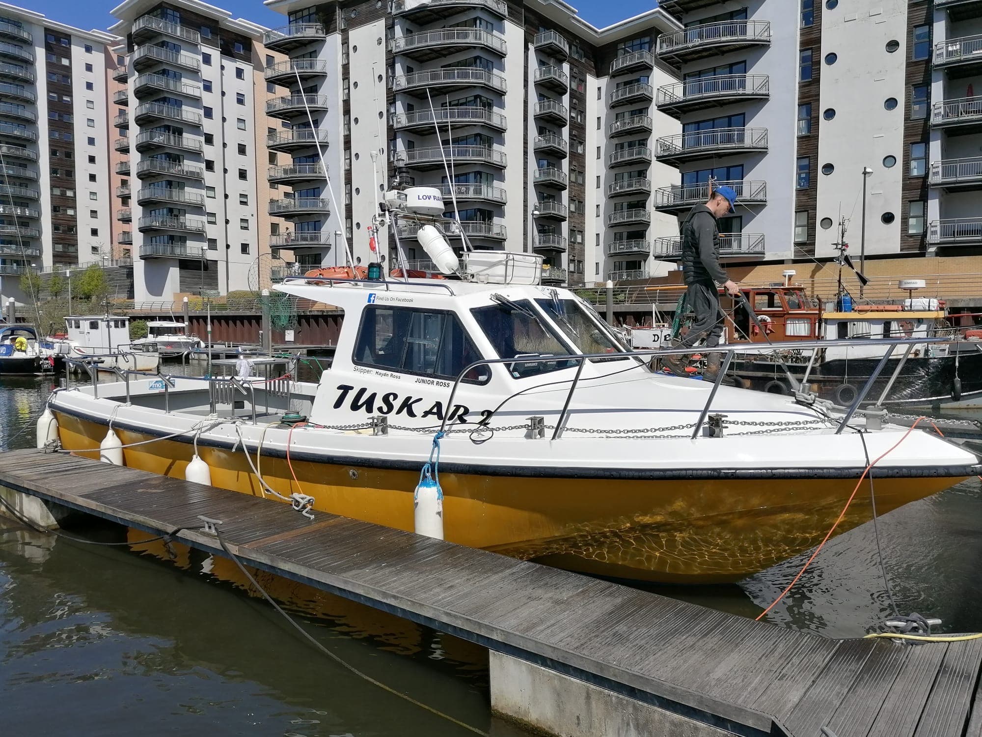 Tuskar 3 moored at Cardiff Marina with the apartments behind