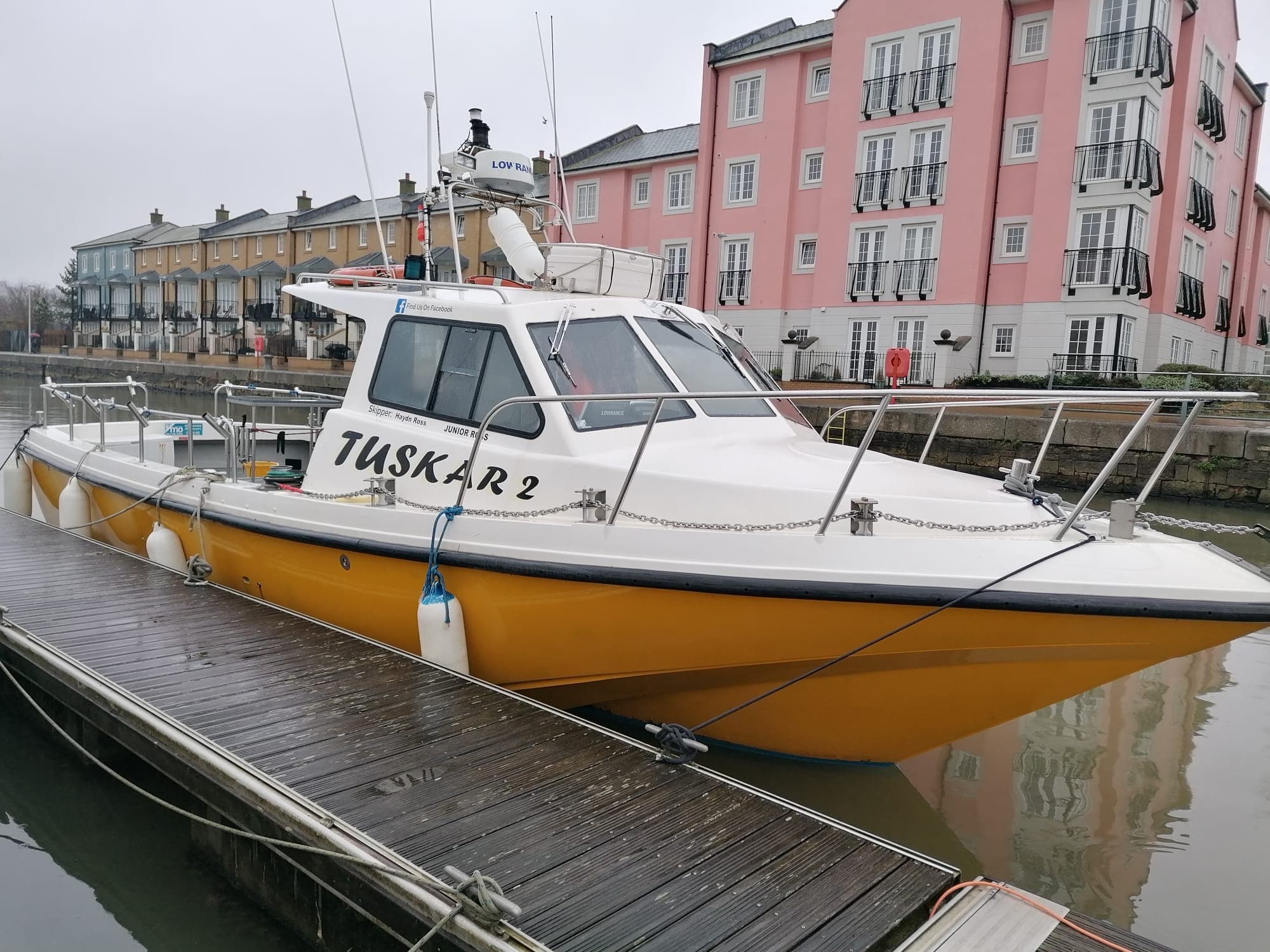 Tuskar 3 moored at Cardiff Marina with the apartments behind